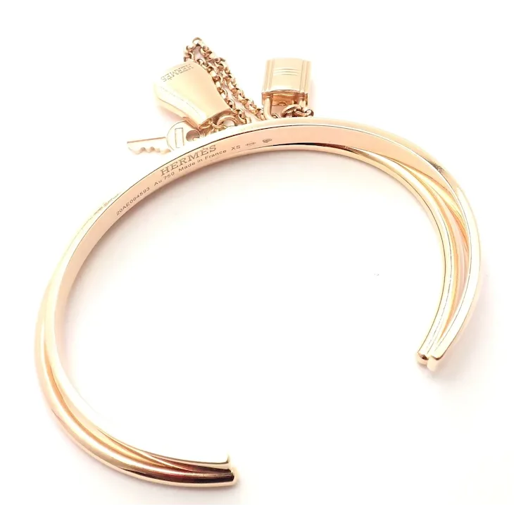 Gold bracelet with a tag on a white background