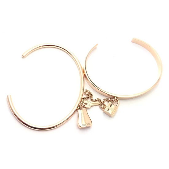 Rose gold hoop earrings with charms on a white background