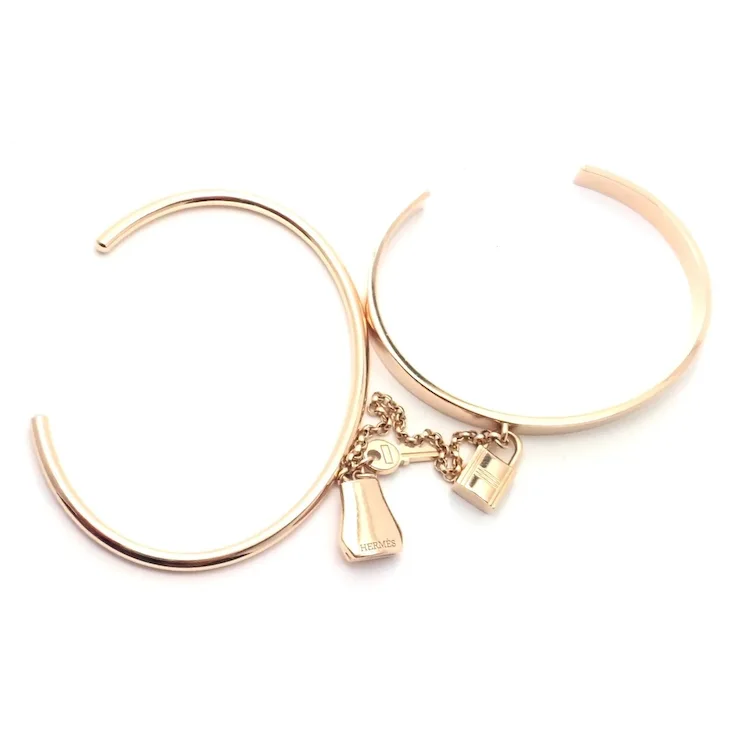 Rose gold hoop earrings with charms on a white background