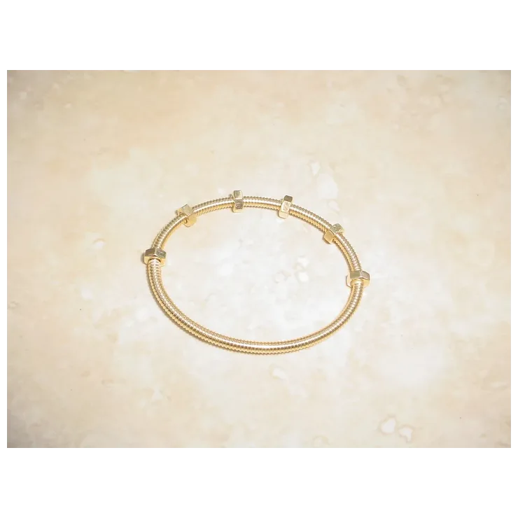 Gold bracelet on a beige background