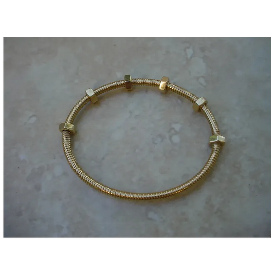 Gold bracelet on a textured surface