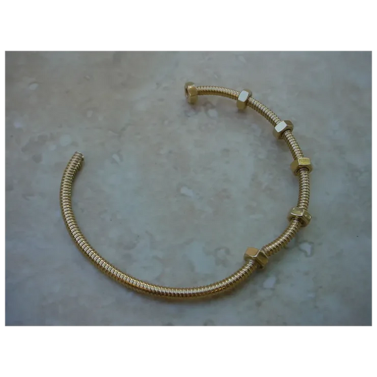 Gold bracelet on a textured surface