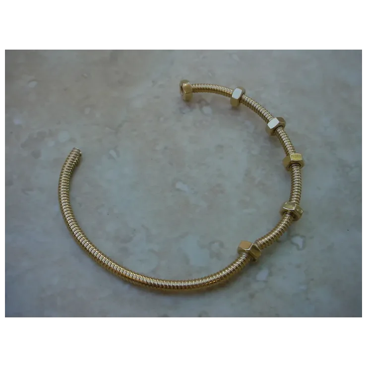 Gold bracelet on a textured surface