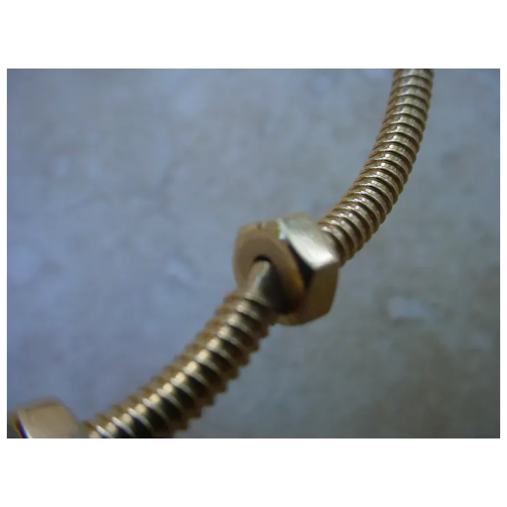 Metallic hose with a fitting on a textured gray background