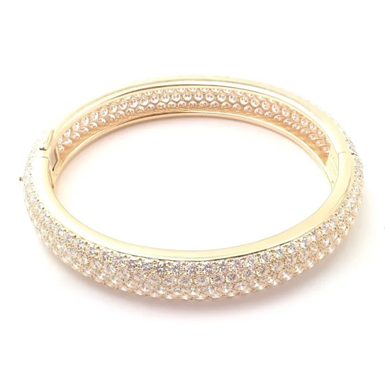 Gold bracelet with clear stones on a white background