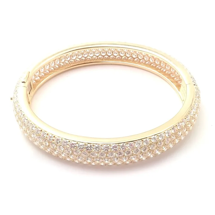 Gold bracelet with clear stones on a white background