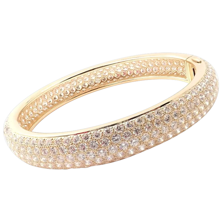 Gold bracelet with clear gemstones on a white background