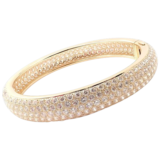 Gold bracelet with clear gemstones on a white background