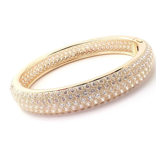 Gold bracelet with diamond accents on a white background