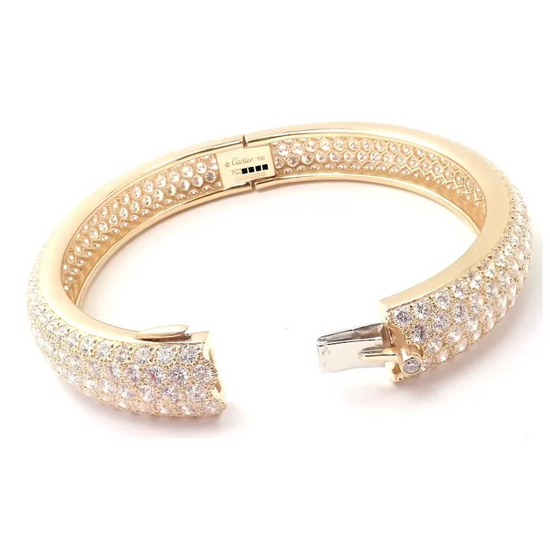 Gold bracelet with diamond accents on a white background
