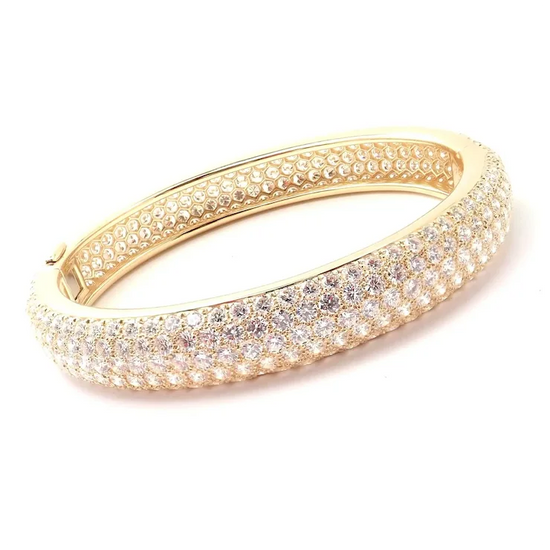 Gold bracelet with clear stones on a white background