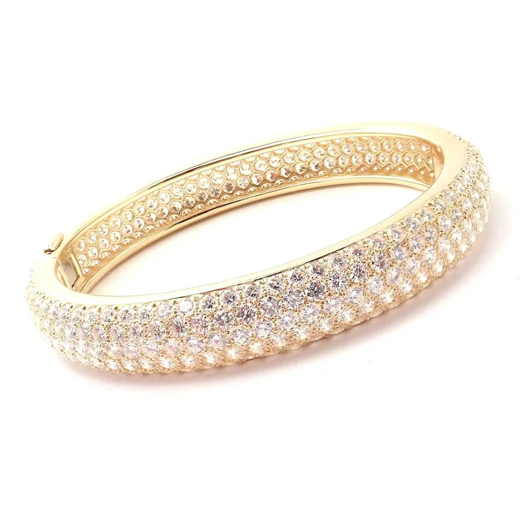 Gold bracelet with clear stones on a white background
