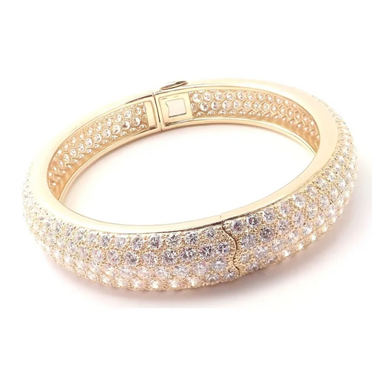 Gold bracelet with clear stones on a white background