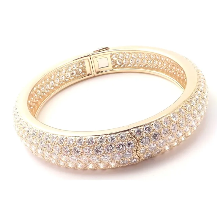 Gold bracelet with clear stones on a white background