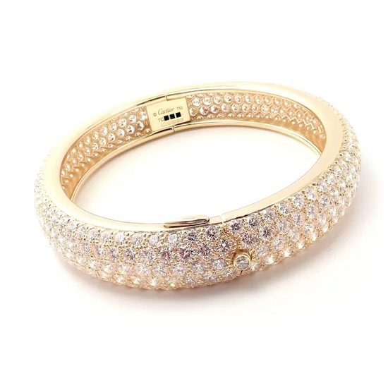 Gold bracelet with clear gemstones on a white background