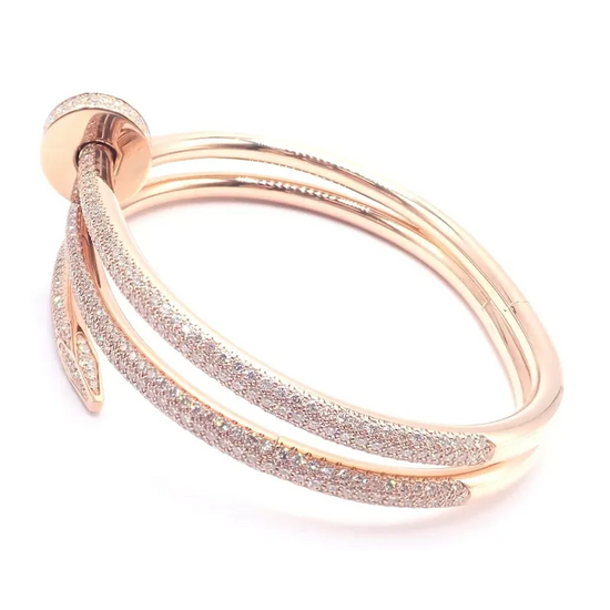 Rose gold bracelet with glittery accents on a white background