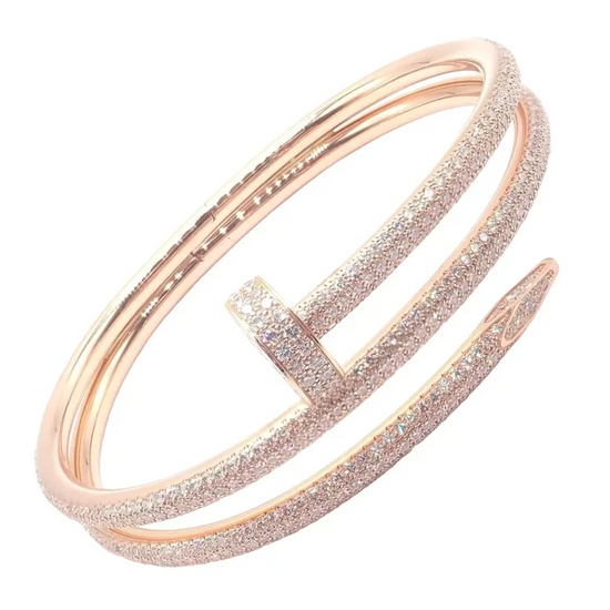 Rose gold bracelet with glittery finish on a white background