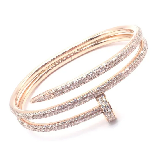 Rose gold bracelet with glittery accents on a white background