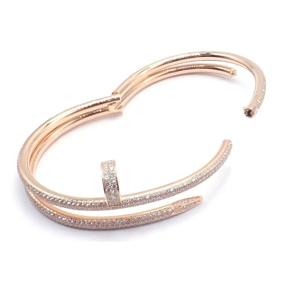 Rose gold bracelet with diamond accents on a white background