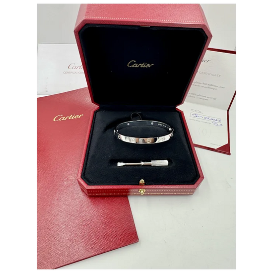 Cartier bracelet in a red box with a certificate of authenticity on a white background