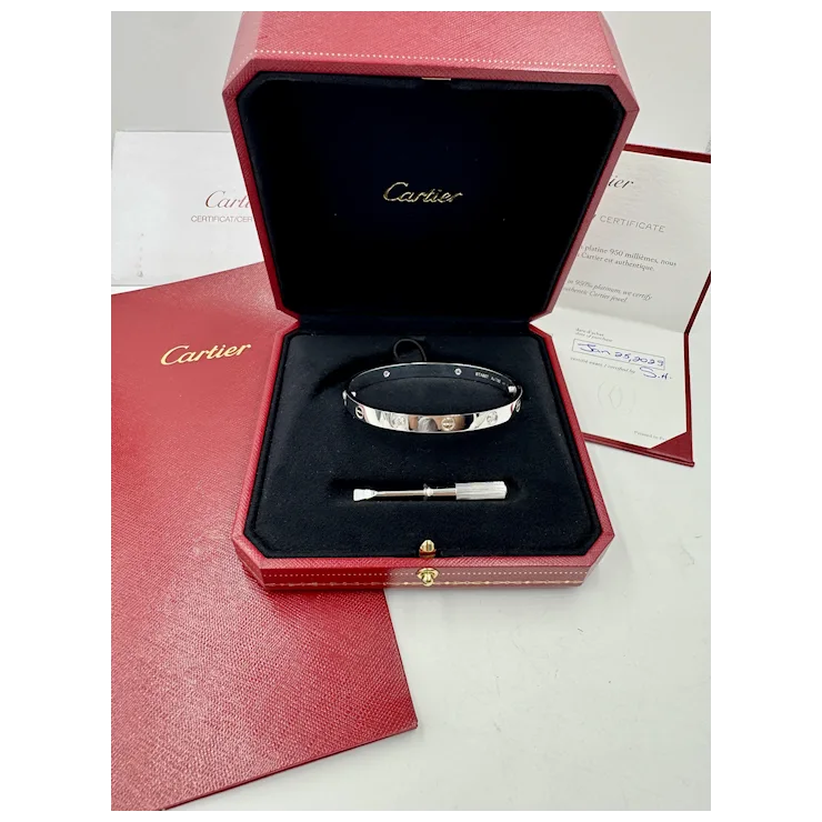 Cartier bracelet in a red box with a certificate of authenticity on a white background
