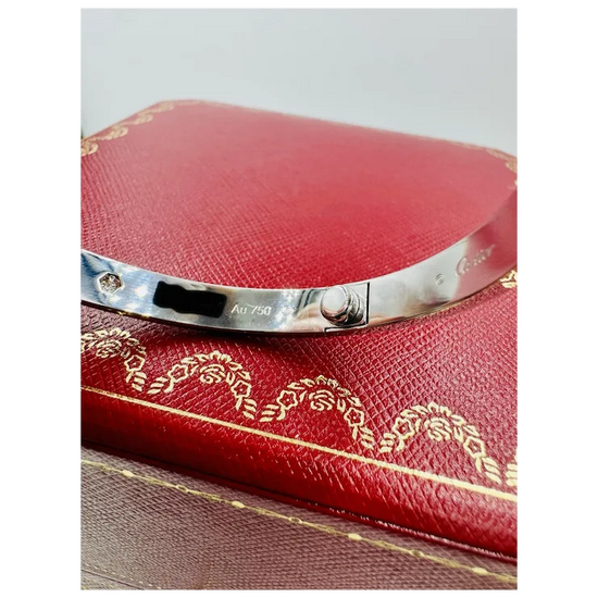 Silver bracelet on a red jewelry box with gold detailing