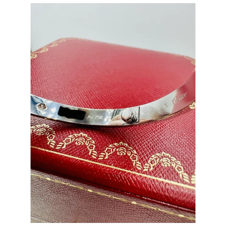 Silver bracelet on a red jewelry box with gold detailing
