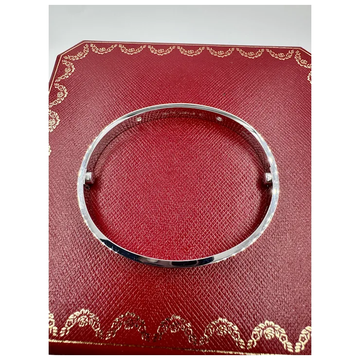 Silver bracelet on a red textured card with gold patterns