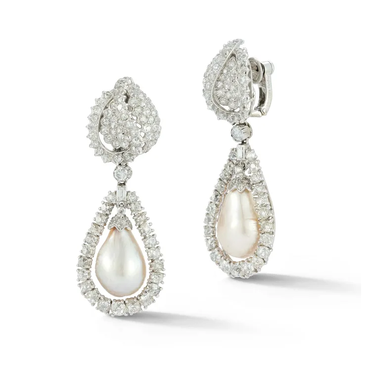 Pair of teardrop-shaped earrings with pearls and diamonds on a white background
