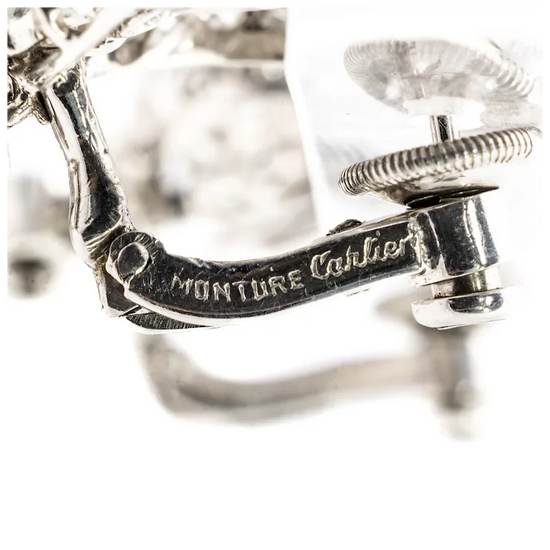 Close-up of a silver ring with 'Monture Cartier' engraving on a white background