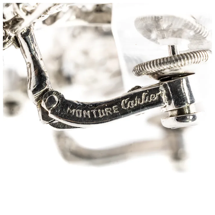 Close-up of a silver ring with 'Monture Cartier' engraving on a white background