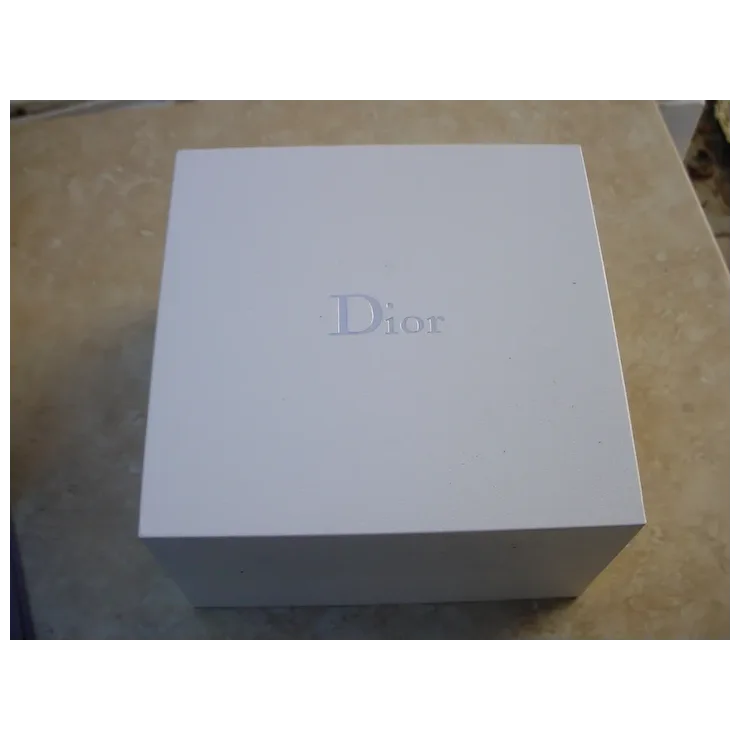 White Dior box on a beige surface
