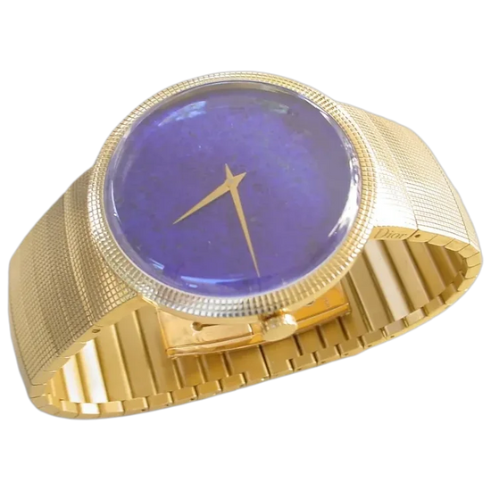 Gold watch with a blue face on a white background