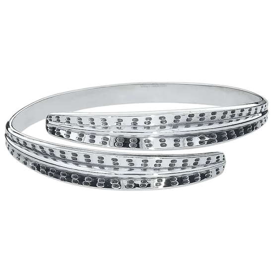 Silver bangles with intricate designs on a white background
