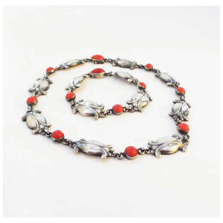 Necklace with red and white stones on a white background