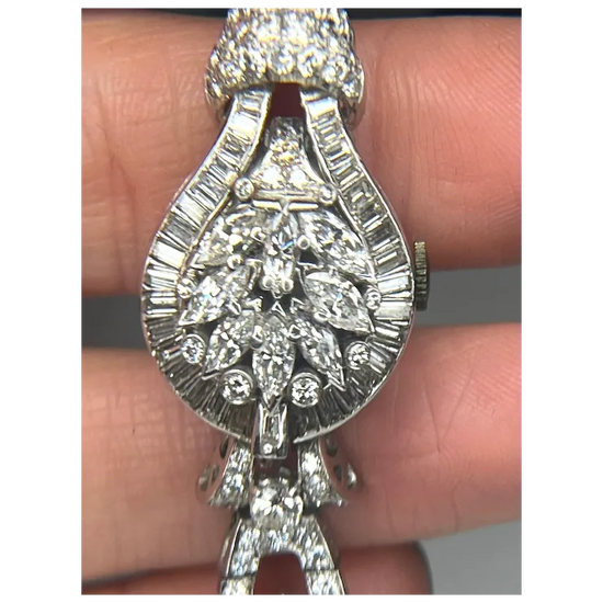 Silver bracelet with diamond accents held between fingers