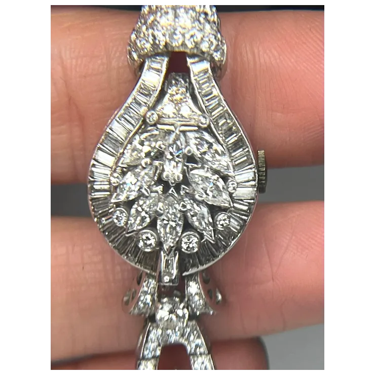 Silver bracelet with diamond accents held between fingers