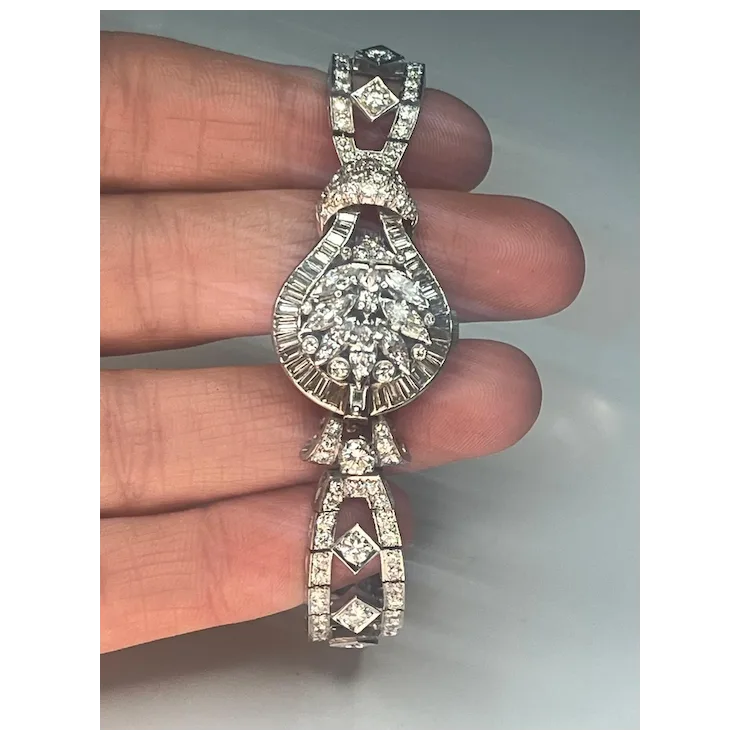 Diamond pendant held between fingers against a neutral background