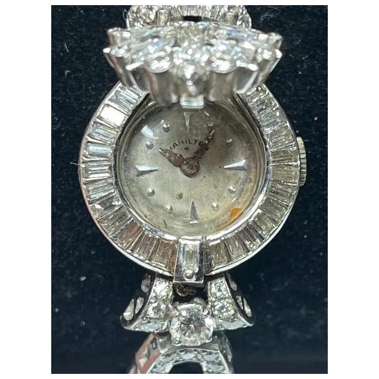 Silver watch with diamond accents on a dark background