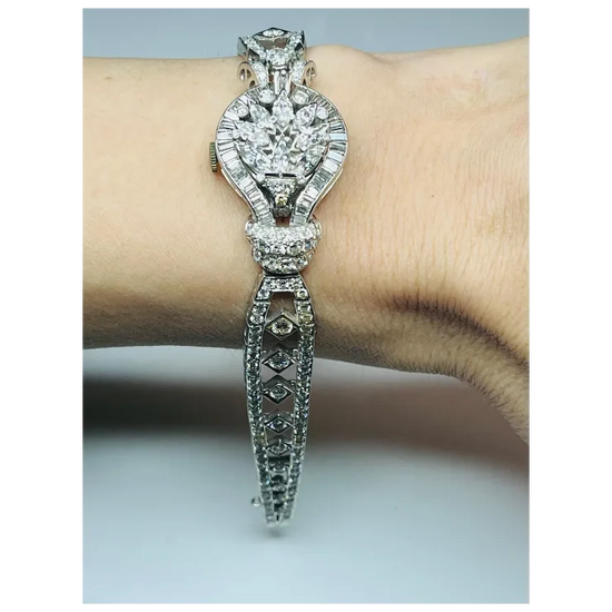 Silver bracelet with diamond accents on a wrist against a neutral background