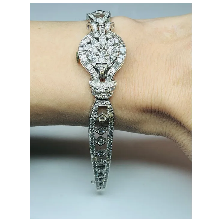 Silver bracelet with diamond accents on a wrist against a neutral background