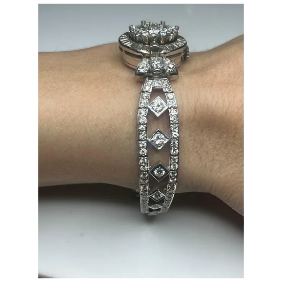Silver bracelet with diamond accents on a wrist against a neutral background