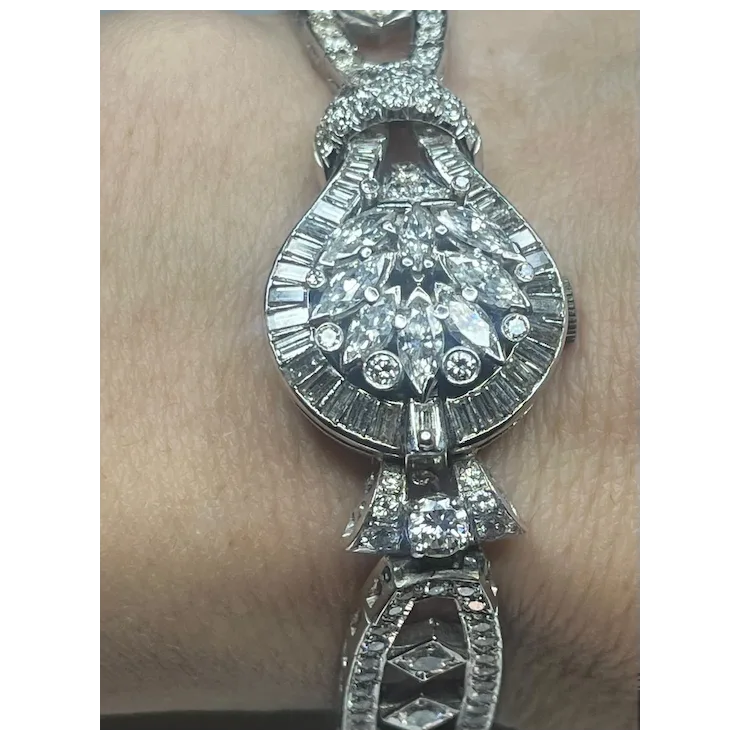Diamond bracelet on a person's wrist with a plain background