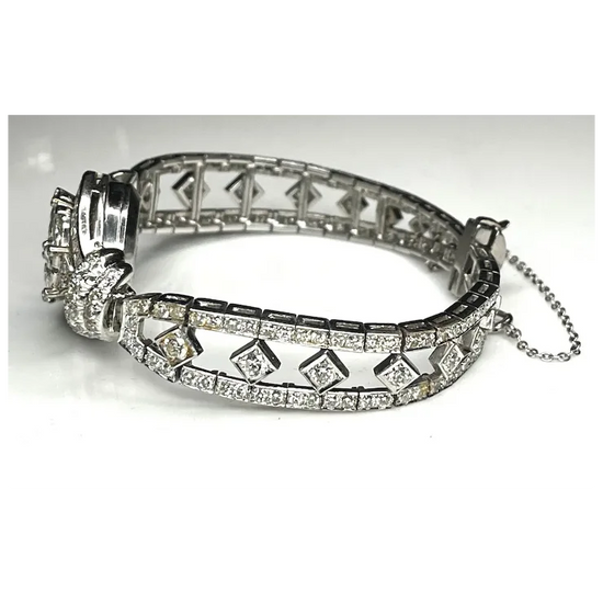 Silver bracelet with diamond accents on a white background
