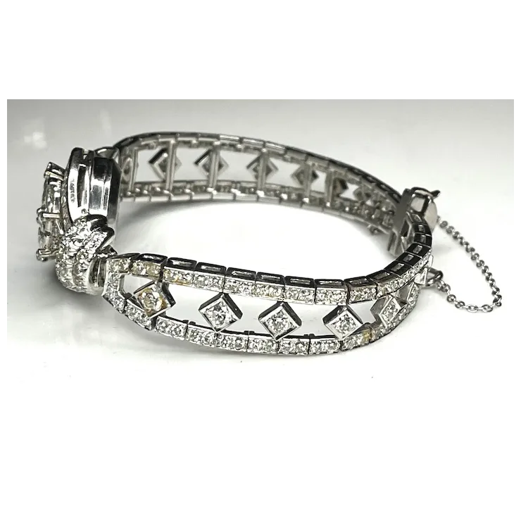 Silver bracelet with diamond accents on a white background
