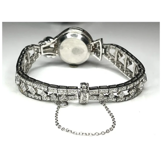 Silver bracelet with clear gemstones on a white background
