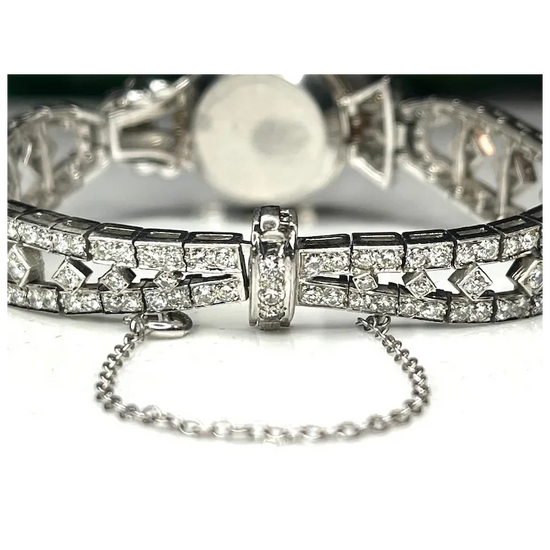 Silver bracelet with diamond accents on a white background