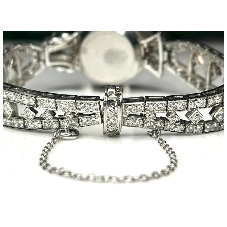 Silver bracelet with diamond accents on a white background