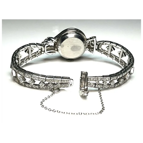 Silver bracelet with diamond-like stones on a white background
