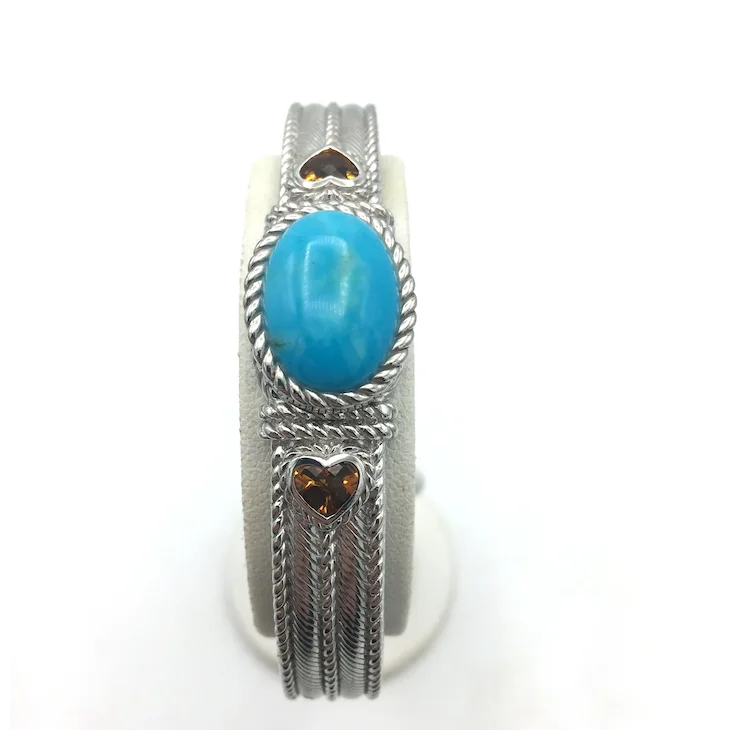 Silver ring with a turquoise stone on a white background